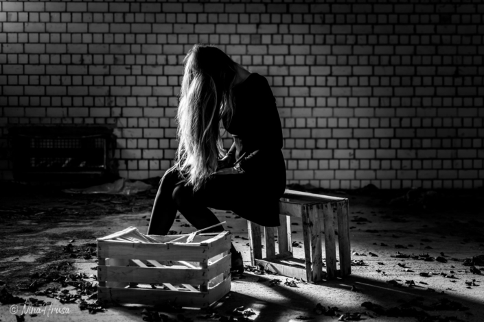 Frau mit langen Haaren, auf Kisten sitzend, lost place, Zwischenmomente | Nina Hrusa Photography